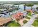 Aerial view showcasing a home with mature trees, a manicured lawn, and waterfront access at 1324 51St Ne Ave, St Petersburg, FL 33703