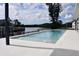 Backyard pool featuring fountains, white tiling, canal views, and black aluminum fencing at 1324 51St Ne Ave, St Petersburg, FL 33703