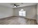 A bright living room is illuminated by a window and features new plank floors at 13506 Copper Head Dr, Riverview, FL 33569