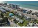 Aerial shot showcasing a coastal home with a road in front and a beach and the ocean beyond at 15548 1St E St, Redington Beach, FL 33708