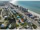 Aerial view of a coastal home with a nearby beach, ocean, and a hotel district at 15548 1St E St, Redington Beach, FL 33708