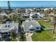 Charming coastal home featuring a well-maintained lawn and a peek of the ocean nearby at 15548 1St E St, Redington Beach, FL 33708