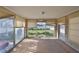 Empty sunroom featuring large windows overlooking the green backyard, ready for customization at 15548 1St E St, Redington Beach, FL 33708