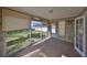 Sunroom with large windows, neutral tile flooring, and a door leading to the backyard at 15548 1St E St, Redington Beach, FL 33708