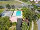 Aerial view of the community pool, playground, and parking area surrounded by lush greenery at 1609 Shady Oaks Dr, Oldsmar, FL 34677