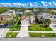 Aerial view of a charming single-story home with a manicured lawn, a two-car garage, and attractive white and orange trim at 1609 Shady Oaks Dr, Oldsmar, FL 34677