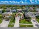 Aerial view of a well-maintained home with lush landscaping, a verdant lawn and beautiful neighborhood at 1609 Shady Oaks Dr, Oldsmar, FL 34677