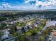 A scenic aerial view of a tranquil residential community nestled among trees, complete with a serene lake at 1609 Shady Oaks Dr, Oldsmar, FL 34677