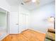 Bedroom with wood floors, closet, ceiling fan, and a floor lamp providing ample lighting at 1609 Shady Oaks Dr, Oldsmar, FL 34677