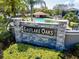 Eastlake Oaks stone community sign surrounded by well-maintained landscaping and beautiful palm trees at 1609 Shady Oaks Dr, Oldsmar, FL 34677