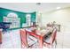 Bright dining room featuring a wooden table set, tile flooring, and large windows at 1609 Shady Oaks Dr, Oldsmar, FL 34677