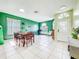 Inviting dining area with tile floors, light green walls, recessed lighting, and a view of a potential office space at 1609 Shady Oaks Dr, Oldsmar, FL 34677