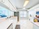 A clean, well lit kitchen featuring white cabinetry, stainless steel appliances, and tile floors at 1609 Shady Oaks Dr, Oldsmar, FL 34677