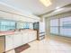 A clean, well lit kitchen featuring white cabinetry, stainless steel appliances, and tile floors at 1609 Shady Oaks Dr, Oldsmar, FL 34677