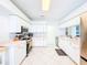 Bright and clean kitchen featuring white cabinetry, stainless steel appliances, and tile floors at 1609 Shady Oaks Dr, Oldsmar, FL 34677