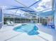 Inviting in-ground pool with a screened enclosure, complemented by lounge chairs for relaxation at 1609 Shady Oaks Dr, Oldsmar, FL 34677