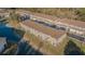 Aerial view of the complex showing roof lines, landscaping, and proximity to water at 18012 Melibee Stone St, Tampa, FL 33647