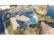 Aerial view of community pool, hot tub, and surrounding parking areas and landscaping at 18012 Melibee Stone St, Tampa, FL 33647