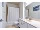 Simple bathroom featuring a shower with curtain, toilet, vanity with sink and white colored walls at 18012 Melibee Stone St, Tampa, FL 33647