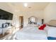 Bright bedroom with a queen bed, wooden floors, and natural light beaming in at 18012 Melibee Stone St, Tampa, FL 33647