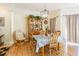 Cozy dining room featuring wood floors, traditional furniture, and a decorative chandelier at 18012 Melibee Stone St, Tampa, FL 33647