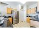 An updated kitchen featuring stainless steel appliances, tile flooring, and ample cabinet space at 18012 Melibee Stone St, Tampa, FL 33647