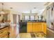 Kitchen with wood cabinets and stainless appliances open to dining area with natural light at 18012 Melibee Stone St, Tampa, FL 33647