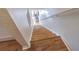 Bright staircase features hardwood steps and white walls creating a clean and inviting transition between floors at 18012 Melibee Stone St, Tampa, FL 33647