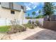 Backyard oasis featuring pavers, tropical plants, and a decorative waterfall at 219 126Th Ave, Treasure Island, FL 33706