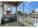 Enjoy the pleasant view of the street from the balcony with comfy chairs and a side table at 219 126Th Ave, Treasure Island, FL 33706