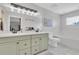 Bright bathroom featuring double sinks, a tub, and modern vanity lighting at 219 126Th Ave, Treasure Island, FL 33706