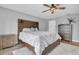 Neutral bedroom with wood-style flooring, bed with accent headboard, and storage furniture at 219 126Th Ave, Treasure Island, FL 33706