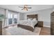 Bright bedroom with balcony access, wood accent wall, and stylish ceiling fan at 219 126Th Ave, Treasure Island, FL 33706