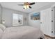 A bright bedroom featuring neutral colors, a mounted television and an exterior view from the window at 219 126Th Ave, Treasure Island, FL 33706