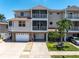 Beautiful three-story exterior featuring multiple balconies and a two-car garage at 219 126Th Ave, Treasure Island, FL 33706