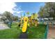 A colorful community playground featuring slides, climbing structures, and soft, artificial turf at 219 126Th Ave, Treasure Island, FL 33706