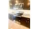 Close-up view of stainless steel oven and microwave, complemented by granite countertops at 2714 Lotus Flower Trl, Wesley Chapel, FL 33543