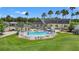 Elevated view of pool and clubhouse, showcasing seating and landscaping at 29307 Schinnecock Hills Ln, San Antonio, FL 33576