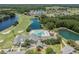 Expansive aerial view of the community highlighting the golf course, lakes, pool and surrounding landscape at 29307 Schinnecock Hills Ln, San Antonio, FL 33576