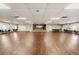 Spacious ballroom with hardwood floors, a stage area, and ample lighting, ideal for events and gatherings at 29307 Schinnecock Hills Ln, San Antonio, FL 33576