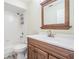 Bathroom with white cabinets, tile floors, tub and shower combination, and modern fixtures at 29307 Schinnecock Hills Ln, San Antonio, FL 33576