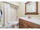 Bathroom with a single vanity, framed mirror, and a shower with a white curtain at 29307 Schinnecock Hills Ln, San Antonio, FL 33576