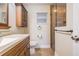 Bathroom featuring a modern vanity, granite countertop, and a glass-enclosed shower at 29307 Schinnecock Hills Ln, San Antonio, FL 33576