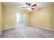 Bright, airy bedroom showcasing neutral walls, carpet, and a ceiling fan at 29307 Schinnecock Hills Ln, San Antonio, FL 33576