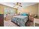 Cozy bedroom with a ceiling fan, plantation shutters, and comfortable furnishings at 29307 Schinnecock Hills Ln, San Antonio, FL 33576