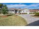 Charming single-story home featuring a well-manicured lawn and a patterned brick driveway at 29307 Schinnecock Hills Ln, San Antonio, FL 33576