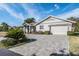 Charming single-story home with a paver driveway and well-manicured landscaping at 29307 Schinnecock Hills Ln, San Antonio, FL 33576