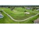 Aerial view of a lush community golf course with pristine greens and tree-lined fairways at 29307 Schinnecock Hills Ln, San Antonio, FL 33576