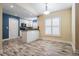 Open-concept kitchen and dining area featuring white cabinets, granite counters, and modern appliances at 29307 Schinnecock Hills Ln, San Antonio, FL 33576