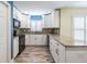 Well-lit kitchen with granite countertops, white cabinets, and modern appliances at 29307 Schinnecock Hills Ln, San Antonio, FL 33576